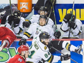 Niagara IceDogs Christopher Paquette (11) is slammed into the London Knights bench by Owen MacDonald (11)in game three of the OHL championship Monday May 9, 2016 at the Meridian Centre in St. Catharines.  (Bob Tymczyszyn/St. Catharines Standard/Postmedia Network)