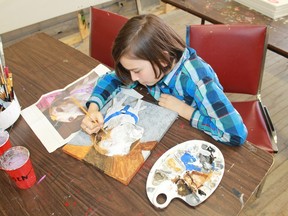 Koen Martin finishes off a portrait of a majestic mutt at his father Francis' Art Shop. 
CARL HNATYSHYN/SARNIA THIS WEEK