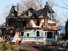 In this Dec. 25, 2011 file photo, firefighters investigate a house in Stamford, Conn., where an early morning fire left five people dead. (AP Photo/Tina Fineberg, File)