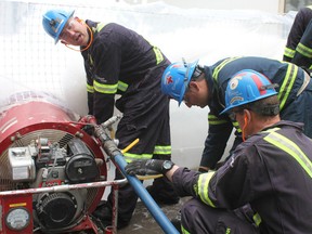 Mine rescue volunteers at the Goderich mine practice using a foam generator that they would use to put out a real fire. (Laura Broadley/Goderich Signal Star)