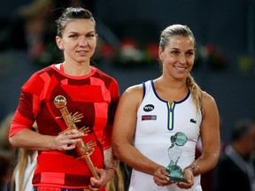 Simona Halep of Romania (left) and Dominika Cibulkova of Slovakia (right) smile while holding their trophies in the women's final at the Madrid Open on May 7, 2016. (Andrea Comas/Reuters)