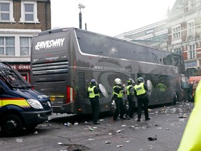 Bottles are thrown at the Manchester United team bus before the team faced West Ham United in Barclays Premier League action in London on Tuesday, May 10, 2016. (Eddie Keogh/Reuters)