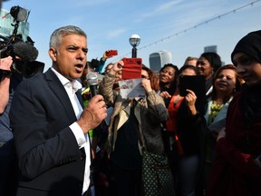 London's newly elected mayor Sadiq Khan speaks to supporters as he arrives for his first day at work at City Hall on May 9, 2016. (REUTERS/Hannah McKay)