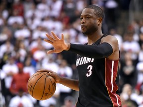 Miami Heat guard Dwyane Wade gestures as he dribbles the ball up court against Toronto Raptors in game one of the second round of the NBA Playoffs at Air Canada Centre. (Dan Hamilton/USA TODAY Sports)