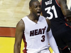 Heat guard Dwyane Wade (3) yells after dunking the ball against the Raptors in overtime during Game 4 of the NBA playoff series in Miami on Monday, May 9, 2016. (Alan Diaz/AP Photo)