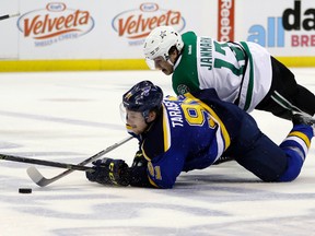 St. Louis Blues' Vladimir Tarasenko and Dallas Stars' Mattias Janmark fall as they chase after a loose puck during the second period of Game 6 of the NHL Western Conference semifinals in St. Louis on May 9, 2016. (AP Photo/Jeff Roberson)