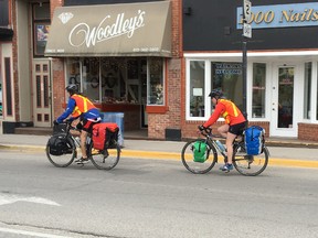 A pair of cyclists pedal their way down King Street in Gananoque. The Gananoque Lions Club would like to help create a network of bicycle paths and routes in the town. (Paul Scott/For Postmedia Network)