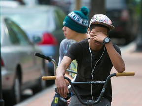 A student cries in front of Howard High School of Technology on Thursday, April 21, 2016 in Wilmington, Del.  A 16-year-old sophomore died Thursday following a fight in a Delaware high school girl's restroom, city officials said. (Suchat Pederson/The Wilmington News-Journal via AP)