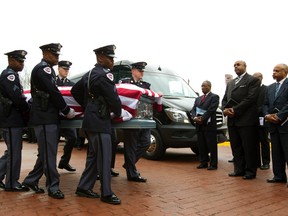 Prince George’s County, Md. police carry team carry the casket of Police Officer First Class Jacai Colson after funeral services at First Baptist Church of Glenarden, Friday, March 25, 2016, in Upper Marlboro, Md. Colson was fatally wounded by his own colleagues as he responded to an attack on his police station by gunmen. (AP Photo/Jose Luis Magana)