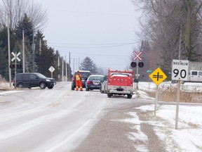 Emergency and railway crews work at the scene of a fatal collision between a Via Rail passenger train and a car at a level crossing north of Melbourne on April 4. Middlesex County faces a legal challenge after the two deaths. (File photo)