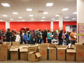 Fire evacuees line up to receive donated clothing and necessities at an Emergency Relief Centre in Edmonton, Alberta on May 10, 2016.