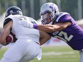 Josh Woodman, shown here tackling an opponent, leads the later round picks by the Eskimos Tuesday in the CFL Draft. (File)