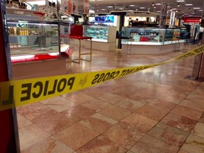 Crime scene tape is seen inside the Macy's at the Silver City Galleria mall in Taunton, Mass., Tuesday, May 10, 2016. Multiple people have been stabbed in separate attacks at the mall and a home in Massachusetts. (Charles Winokoor/The Daily Gazette via AP)