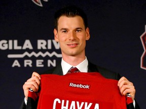 Newly appointed Coyotes GM John Chayka holds a jersey after a news conference announcing his promotion in Glendale, Ariz., on Thursday, May 5, 2016. Chayka, 26, is the youngest GM in NHL history. (Matt York/AP Photo)