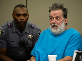 In this Dec. 9, 2015 file photo, Robert Lewis Dear talks to Judge Gilbert Martinez during a court appearance in Colorado Springs, Colo. The man accused of killing three people and wounding nine others in a shooting rampage last year at a Planned Parenthood clinic has been declared incompetent to stand trial. (Andy Cross/The Denver Post via AP, Pool, File)