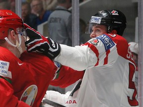 Canada’s Mark  Scheifele, right, fights with Roman Dyukov of Belarus  during the Hockey World Championships Group B match in St.Petersburg, Russia, Monday, May 9, 2016. (AP Photo/Dmitri Lovetsky)