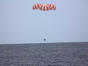 In this photo released by SpaceX, a SpaceX capsule containing science samples from NASA's one-year space station resident, approaches the Pacific Ocean, a few hundred miles off the Southern California coast, Wednesday, May 11, 2016. Nearly 4,000 pounds of items fill the Dragon, including blood and urine samples from astronaut Scott Kelly's one-year mission. Kelly returned to Earth in March and has since retired from NASA. Researchers will use the medical specimens to study how the body withstands long journeys in space, in preparation for an eventual mission to Mars in the 2030s.  (SpaceX via AP)