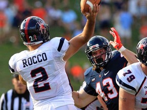 Virginia defensive end Trent Corney (43) puts pressure on Richmond quarterback Michael Rocco during an NCAA football game during the 2014 season. Corney was selected ninth overall by the Winnipeg Blue Bombers in the CFL Draft on Tuesday night. (Associated Press file photo)