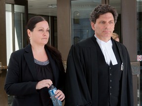 Roxanne Carr exits the Ottawa Courthouse with her lawyer Lawrence Greenspon during a break in proceedings on Wednesday May 11, 2016. Errol McGihon/Postmedia