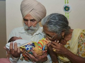 Daljinder Kaur and husband Molinder Singh Gill hold their baby.