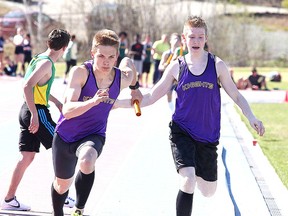 Brodie Erwin of Lo Ellen Park Secondary School hands off to Lucas Mrozewski during the final leg of the midget boys 4x400 relay at the Laurentian Community Track Complex in Sudbury, Ont. on Wednesday May 11, 2016. Gino Donato/Sudbury Star/Postmedia Network