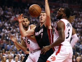 Miami Heat point guard Goran Dragic tries to control a loose ball against Toronto Raptors point guard Cory Joseph (6) and forward DeMarre Carroll (5) in Game 5. (USA Today Sports)
