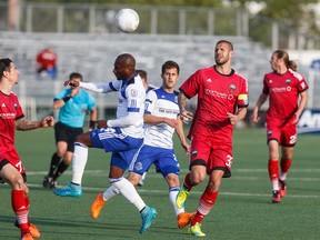 Edmonton's Sainey Nyassi (centre) heads the ball through Ottawa defenders during a NASL game between FC Edmonton and the Ottawa Fury at Clarke Stadium Wednesday. (Ian Kucerak)