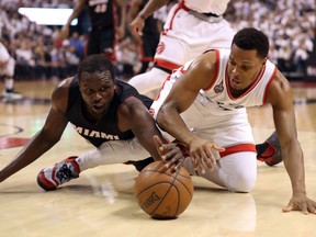 Toronto Raptors point guard Kyle Lowry (7) battles for a loose ball with Miami Heat forward Luol Deng (9) in Game 5. (USA Today Sports)