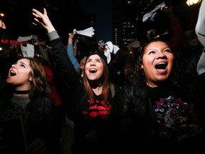 Raptors fans Noa Henderson, Kasey Washenfelder, and Michelle Wrobel watch the Game 5 action outside of the Air Canada Centre in 'Jurassic Park' on May 11, 2016. (Stan Behal/Toronto Sun)