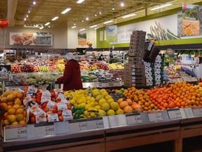 A shopper is seen in a Loblaws produce section in Montreal on Monday, March 9, 2015.Ugly food can mean a pretty profit. (THE CANADIAN PRESS/Ryan Remiorz)