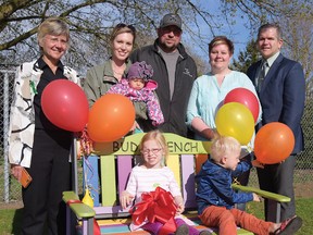 St. Joseph's Catholic School in Tillsonburg held an official ribbon-cutting ceremony Wednesday night during their Education Week Open House for the school's new Buddy Bench. From left are (on the bench) Adianna and Matthijs VanLeeuwen, (back row) Linda Staudt, Director of Education (London District Catholic School Board), Jessica (holding Anneke) and Tyson VanLeeuwen, St. Joseph's Crystal Vandenbroek, and St. Joseph's principal Jim Naphin. (CHRIS ABBOTT/TILLSONBURG NEWS)