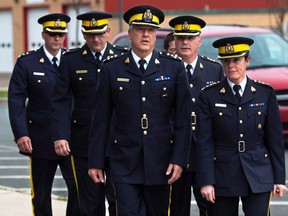 A group of senior RCMP officers, led by Assistant Commissioner Roger Brown, centre, head of the RCMP in New Brunswick, arrives at Moncton Law Courts for the sentencing for Justin Bourque in Moncton, N.B., in an October 31, 2014, file photo. The RCMP has pleaded not guilty in the case of alleged Labour Code violations by the RCMP related to the force's response to a June 2014 shooting rampage in Moncton, N.B. THE CANADIAN PRESS/Andrew Vaughan