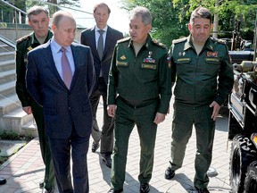 Russian President Vladimir Putin, left, inspects military vehicles after a meeting with military and defence industries' officials in the Bocharov Ruchei residence in Sochi, Russia, Thursday, May 12, 2016. (Mikhail Klimentyev/Sputnik, Kremlin Pool Photo via AP)