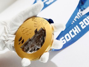 A gold medal manufactured for the 2014 Winter Olympic Games in Sochi, is seen on display at the Adamas jewellery factory in Moscow on June 28, 2013. A report Thursday claims multiple Russian athletes took part in a state-run doping program for the Sochi Games. (Sergei Karpukhin/Reuters/Files)