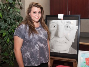 Grade 11 Kristie Simmons stands beside her art piece Forgotten, inspired by senior depression, at the VIBE Children and Youth Mental Health Art Gala on Tuesday, May 3. Taylor Hermiston/Vermilion Standard/Postmedia Network.