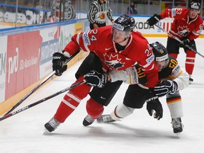 Canada's Corey Perry (left) fights for the puck with Germany's Patrick Hager during the world hockey championship in St.Petersburg, Russia, on Thursday, May 12, 2016. (Dmitri Lovetsky/AP Photo)