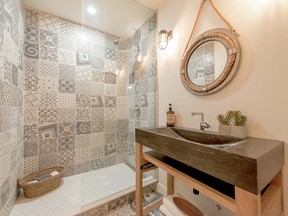 A huge walk-in shower complete with dramatic tiles gives the bathroom a distinctive style.