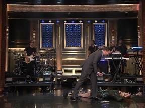 Meghan Trainor lies flat on her back after falling at the end of her performance on "The Tonight Show Starring Jimmy Fallon."