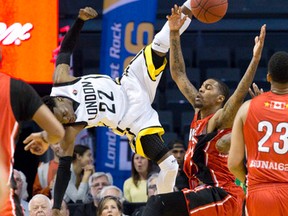 London Lightning?s Tyshawn Patterson tumbles to the floor after battling Brandon Robinson of the Windsor Express for possession of the ball during Game 1 of the National Basketball League of Canada Central Division final at Budweiser Gardens on Thursday night.  (CRAIG GLOVER, The London Free Press)