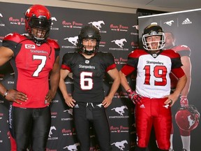 Stampeders players (left to right) Junior Turner, Rob Maver and Bo Levi Mitchell pose with the team's newly styled uniforms which were unveiled in Calgary on Thursday, May 12, 2016. (Jim Wells/Postmedia Network)