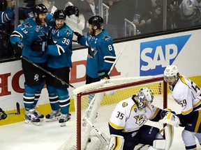 Sharks' Joe Thornton (left) celebrates with Logan Couture (39) and Joe Pavelski (8) after scoring a goal against Predators goalie Pekka Rinne (35) during the third period of Game 7 of the NHL Western Conference semifinal playoff series in San Jose, Calif., on Thursday, May 12, 2016. (Ben Margot/AP Photo)