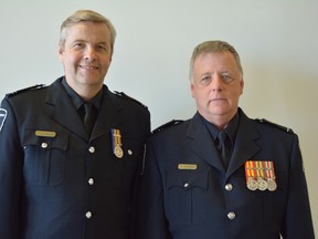 Joe Ferguson (left) and Dale Hodgins receive the Ontario Award for Paramedic Bravery.