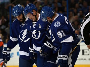 Lightning defenceman Anton Stralman (6) gets helped off the ice by defenceman Jason Garrison (5) and centre Steven Stamkos (91) against the Islanders during NHL action in Tampa, Fla., on March 25, 2016. (Kim Klement/USA TODAY Sports)