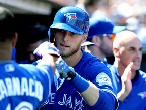 Blue Jays outfielder Michael Saunders is greeted in the dugout after his solo home run in the ninth inning against the Giants tied up the game during MLB action in San Francisco on May 11, 2016. (Lance Iversen/USA TODAY Sports)