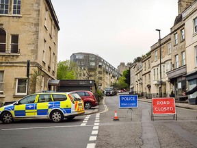 Police divert away traffic from an exclusion zone set up after contractors unearthed a Second World War shell in Bath, England, Friday, May 13, 2016. (Ben Birchall/PA via AP)