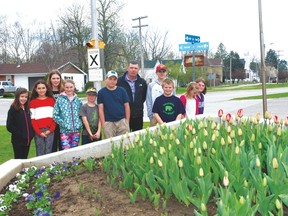 Dutton/Dunwich Mayor Cameron McWilliam and Dunwich Dutton Public School students stand in front of the planter at the Dutch-Canadian Friendship Garden in front of the Dutton Fire Department at a blooming ceremony last week.