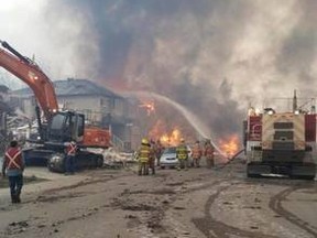 Thompson Bros of Spruce Grove uses their equipment to help keep the wildfire from spreading in Fort McMurray. Local firefighters and businesses are offering their support in battling the flames. - Photo supplied