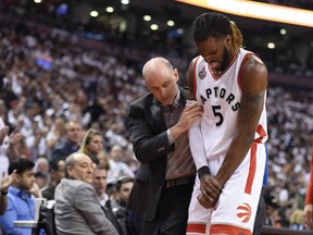 Raptors' DeMarre Carroll is helped off the court after an injury to his wrist during second half NBA playoff action against the Heat in Toronto on Wednesday, May 11, 2016. THE CANADIAN PRESS/Frank Gunn