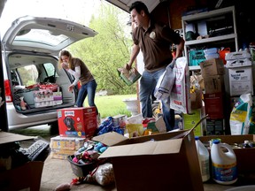 Emily Mountney-Lessard/The Intelligencer
Stephanie Pignoli, with help from her husband Carlos Ferreira and nephew Tyler Duffy, loads pet-related donations into her van on Friday. The donations will head to Fort McMurray Monday.