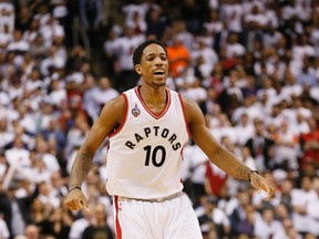DeMar DeRozan reacts after a Kyle Lowry basket as the Raptors tie the series in Game 2 against the Heat  in Toronto on Thursday, May 5, 2016. (Stan Behal/Toronto Sun)